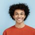A vibrant collection of cheerful faces showcases a diverse group of people expressing happiness. Each person radiates positivity against a colorful backdrop, embodying unity in diversity.